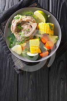 Caldo de resÃÂ is a traditional Mexican beef soup made with beef chunks and vegetables closeup in the plate. Vertical top view